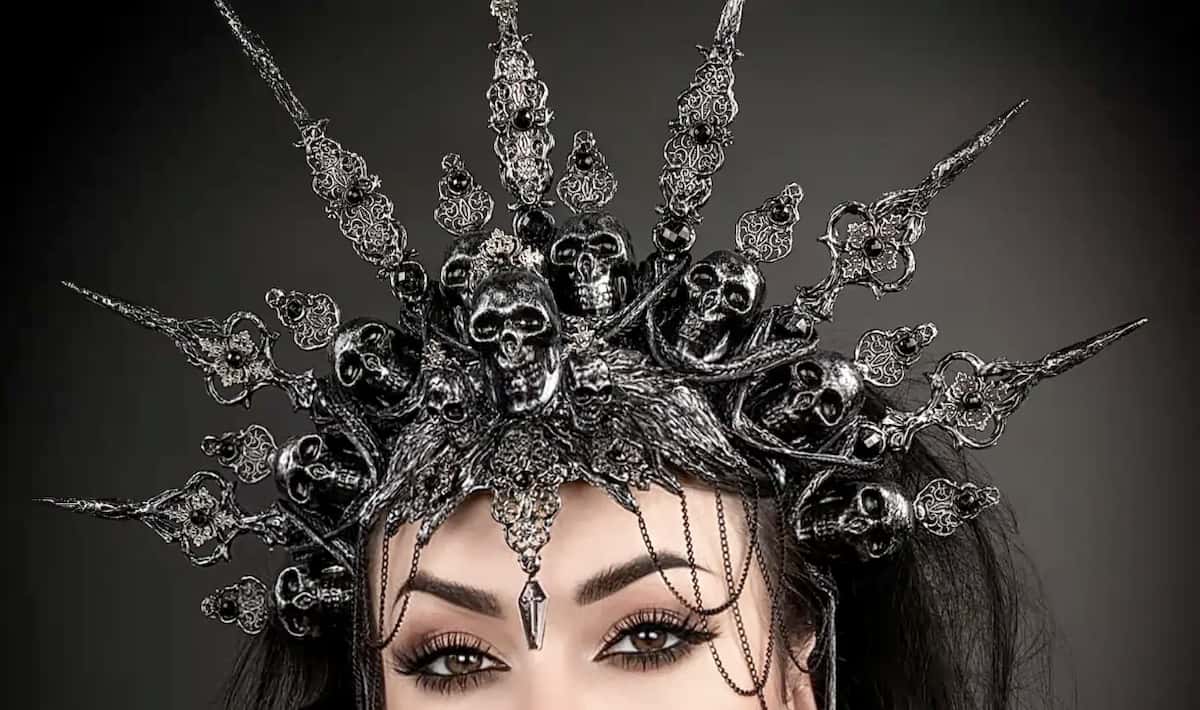 Gothic bride wearing a large pewter skull headdresses for her goth wedding