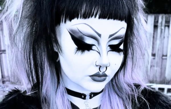Picture of trad goth makeup with a flawless white base using white foundation and white setting powder.